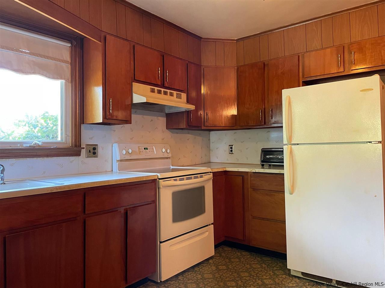 307 Blue Mountain Road Saugerties, NY 12477 - Photo 6 of 20 a kitchen with a sink a stove and a refrigerator