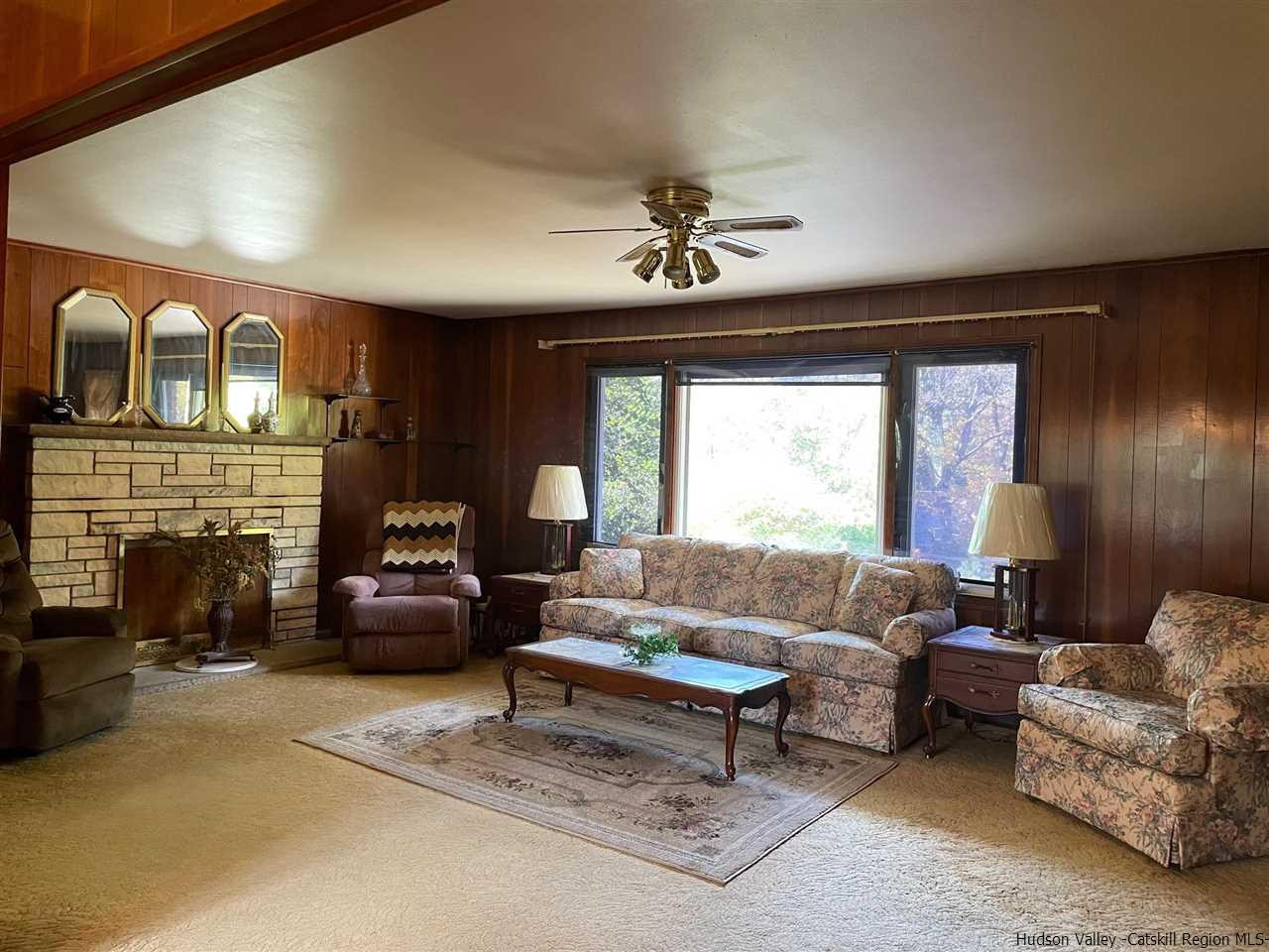 307 Blue Mountain Road Saugerties, NY 12477 - Photo 8 of 20 a living room with furniture a fireplace and a flat screen tv