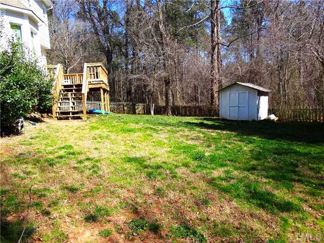 4305 Fathom Court Raleigh, NC 27606 - Photo 10 of 16 Fenced and flat backyard. Facing green zone for extra privacy with fruit trees and play area for kids or pets.