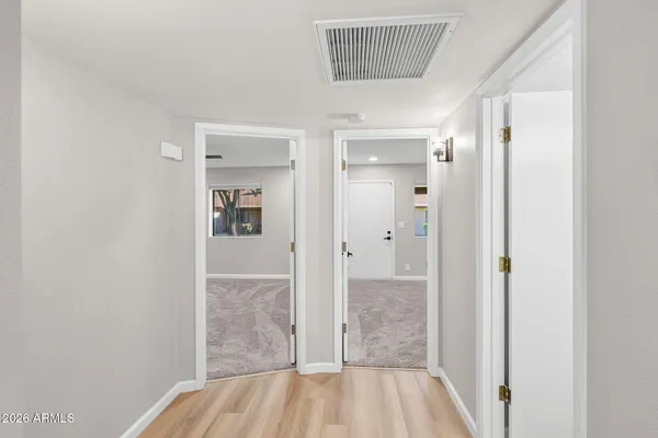 a bedroom with a bed couches and window