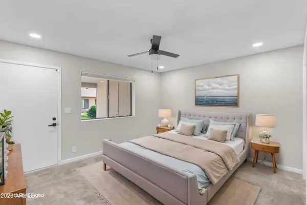 an empty room with a ceiling fan and a window