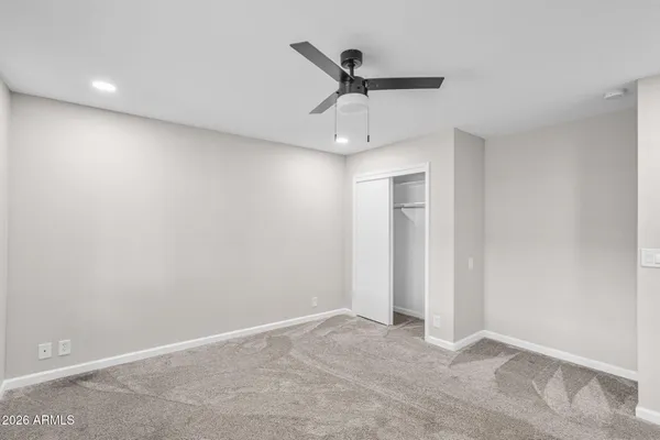 a bathroom with a sink a toilet a mirror and shower