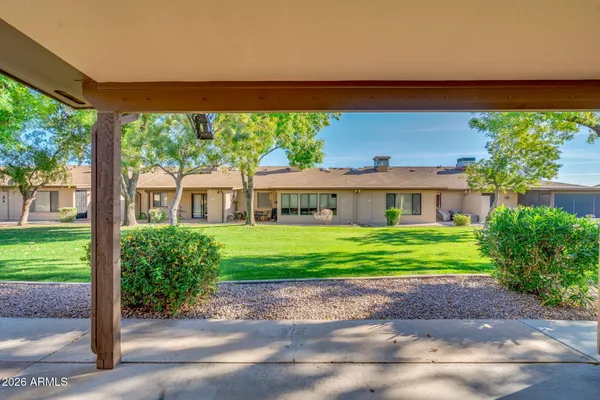 a view of a house with a yard and sitting area