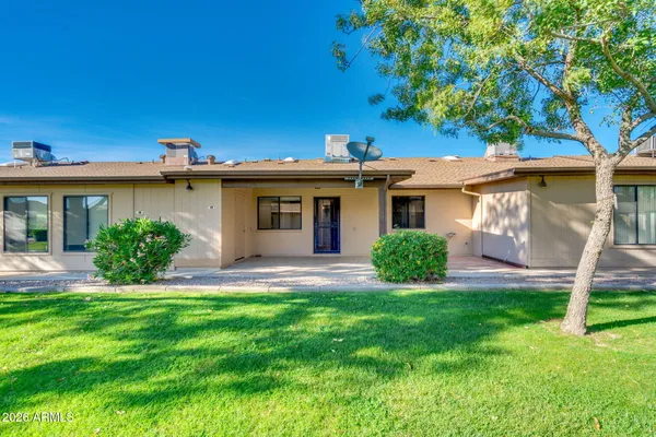an aerial view of a tennis ground and a lots of buildings in the background