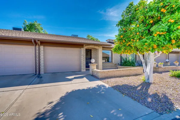 a front view of a house with garden