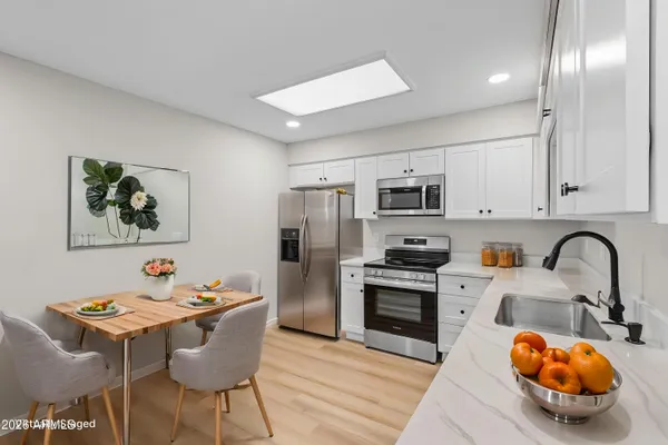 a kitchen with stainless steel appliances granite countertop a sink and cabinets