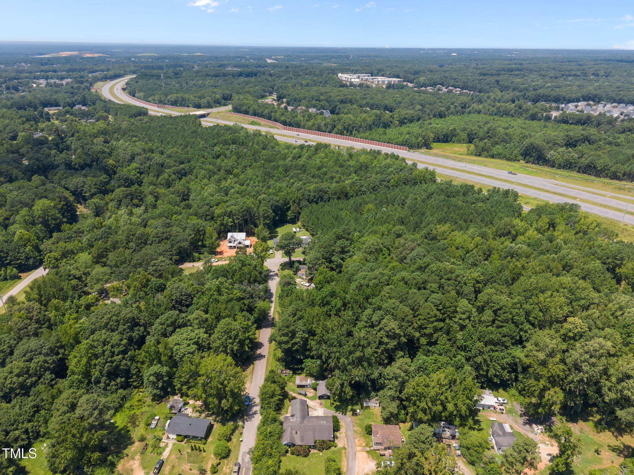 9640 Holly Springs Road Apex, NC 27539 - Photo 11 of 23 an aerial view of green landscape with trees houses and mountain view