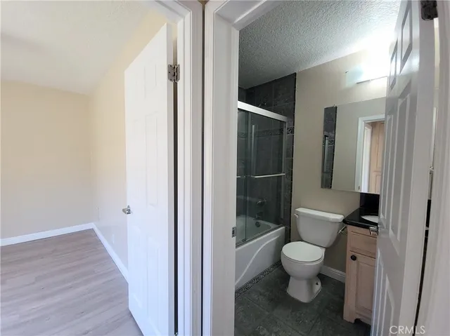 a white toilet sitting next to a bathroom sink