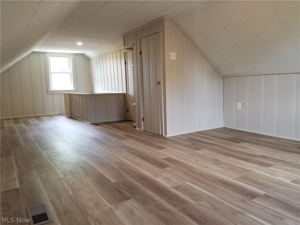 5671 Wellington Road Cleveland, OH 44124 - Photo 15 of 26 Bonus room with vaulted ceiling and hardwood / wood-style floors