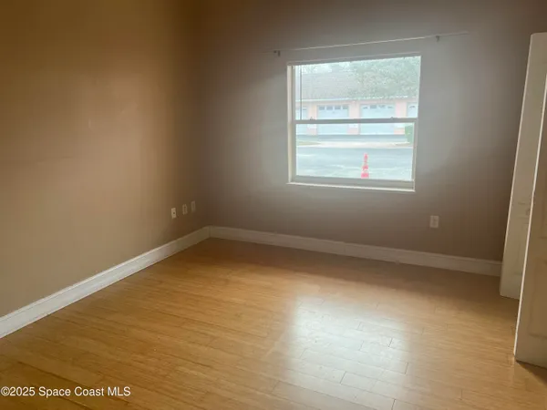 a view of an empty room with a window