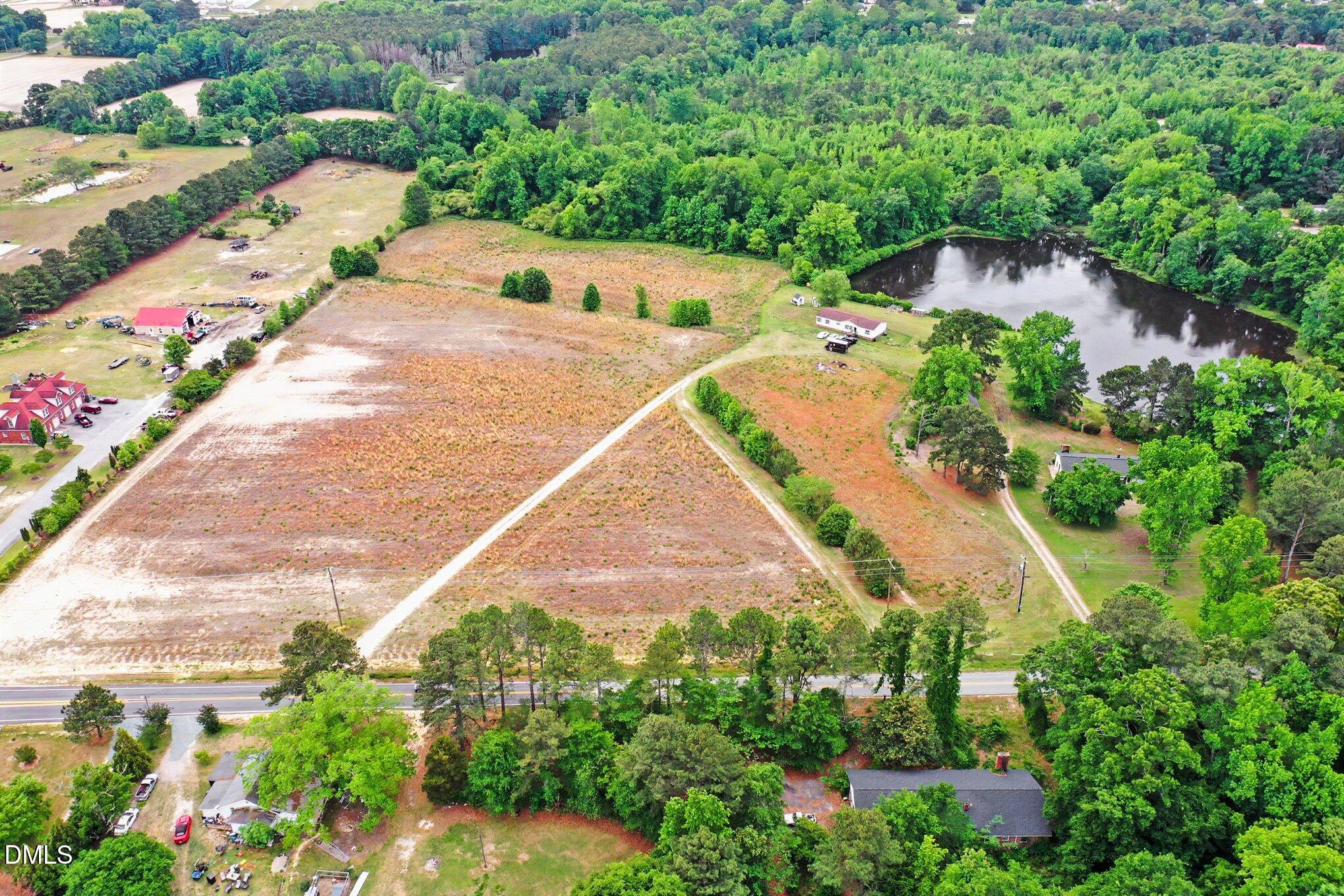 6709 Wimberly Road Willow Spring, NC 27592 - Photo 1 of 23 an aerial view of a house with a yard and garden