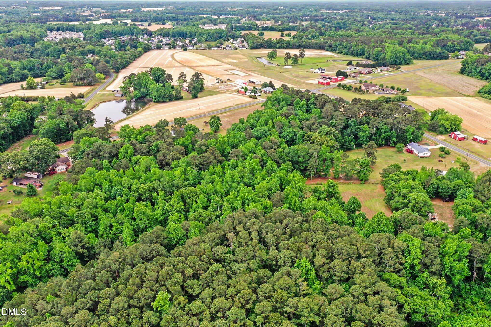 6709 Wimberly Road Willow Spring, NC 27592 - Photo 5 of 23 an aerial view of residential houses with outdoor space and trees all around