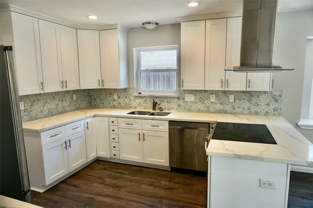 a kitchen with a sink cabinets and window
