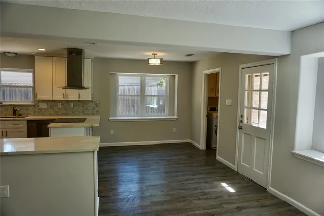 a bathroom with a granite countertop toilet sink and mirror
