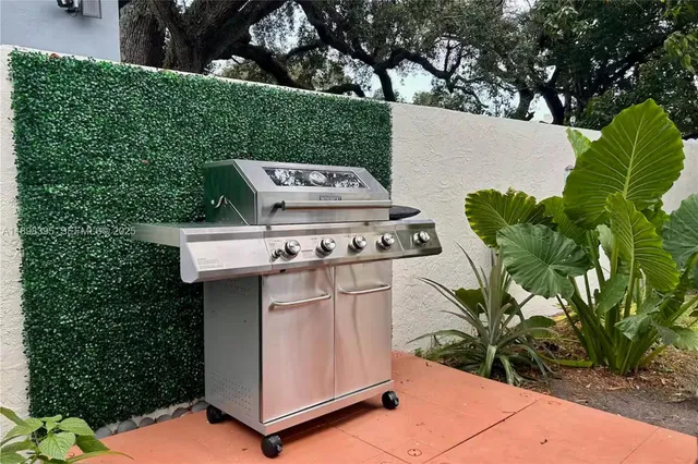a white house with a yard and plants
