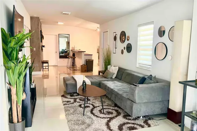 a living room with furniture and a potted plant