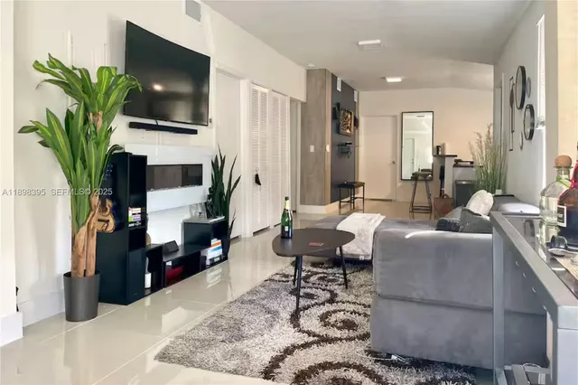 a living room with furniture fireplace and flat screen tv