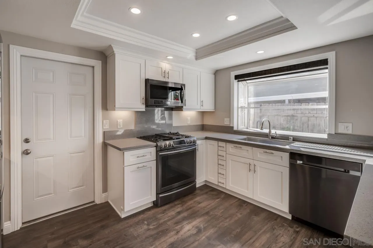 10224 Pebble Beach Drive Santee, CA 92071 - Photo 11 of 30 a kitchen with a sink stove and microwave