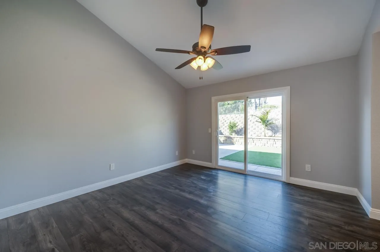 10224 Pebble Beach Drive Santee, CA 92071 - Photo 14 of 30 an empty room with wooden floor fan and windows