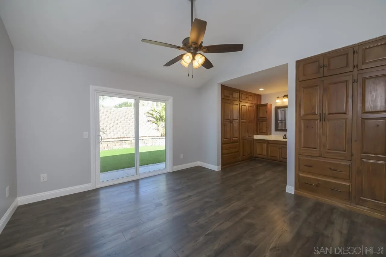 10224 Pebble Beach Drive Santee, CA 92071 - Photo 16 of 30 a view of an empty room with window hardwood floor and a ceiling fan