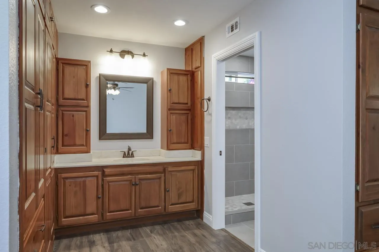 10224 Pebble Beach Drive Santee, CA 92071 - Photo 17 of 30 a bathroom with a double vanity sink and mirror