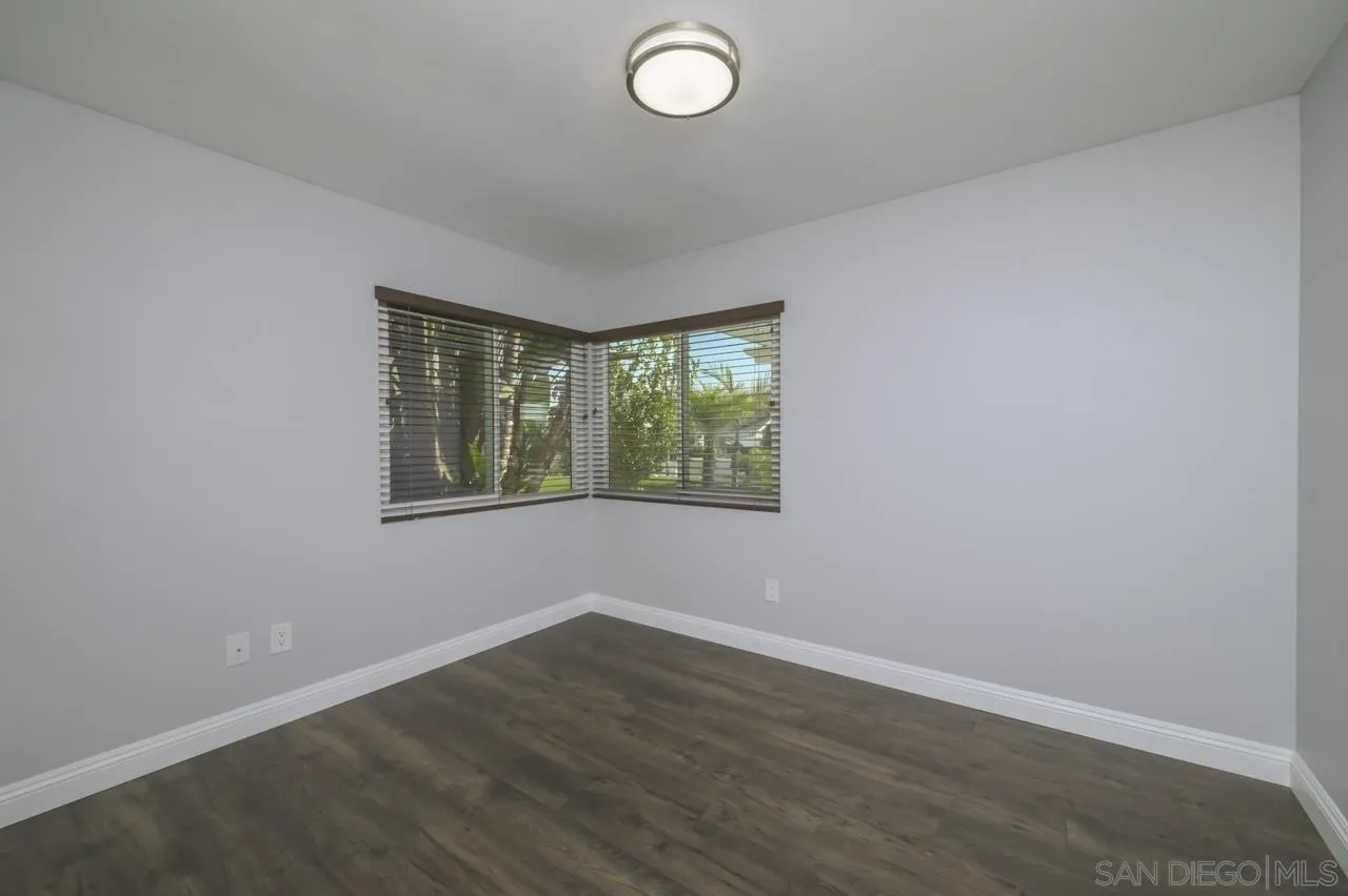 10224 Pebble Beach Drive Santee, CA 92071 - Photo 19 of 30 an empty room with wooden floor and windows