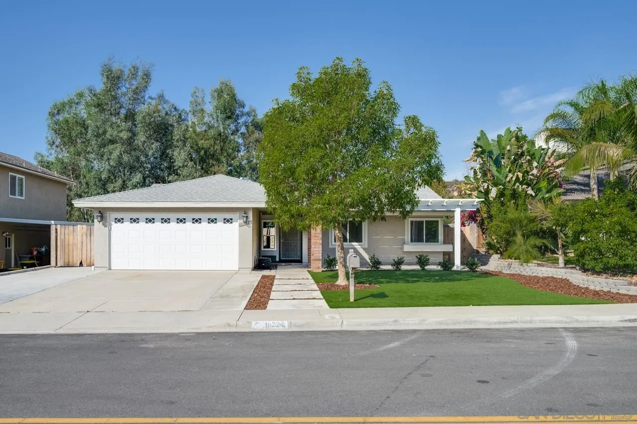 10224 Pebble Beach Drive Santee, CA 92071 - Photo 2 of 30 a front view of a house with a yard and garage