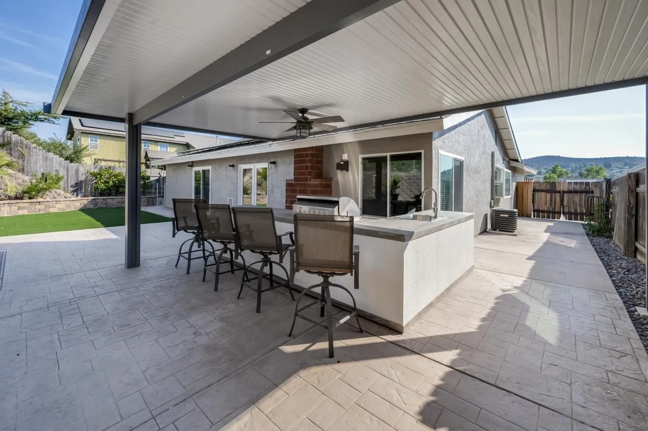 10224 Pebble Beach Drive Santee, CA 92071 - Photo 26 of 30 a view of a patio with table and chairs potted plants with wooden floor