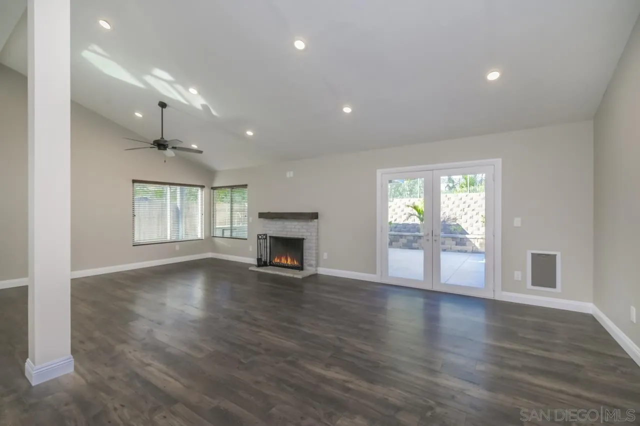 10224 Pebble Beach Drive Santee, CA 92071 - Photo 4 of 30 an empty room with wooden floor fireplace and windows