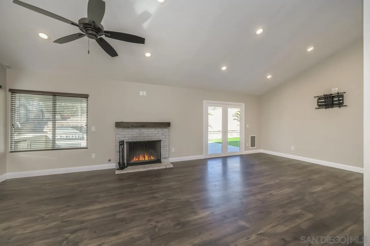 10224 Pebble Beach Drive Santee, CA 92071 - Photo 5 of 30 an empty room with windows and a fireplace