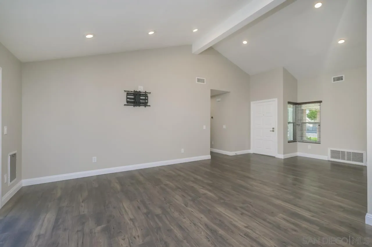 10224 Pebble Beach Drive Santee, CA 92071 - Photo 6 of 30 an empty room with wooden floor and windows