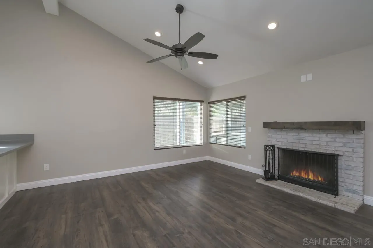 10224 Pebble Beach Drive Santee, CA 92071 - Photo 8 of 30 a view of an empty room with wooden floor fireplace and a window