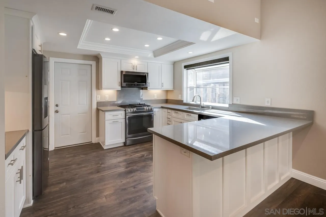10224 Pebble Beach Drive Santee, CA 92071 - Photo 9 of 30 a kitchen with stainless steel appliances granite countertop a sink stove and refrigerator