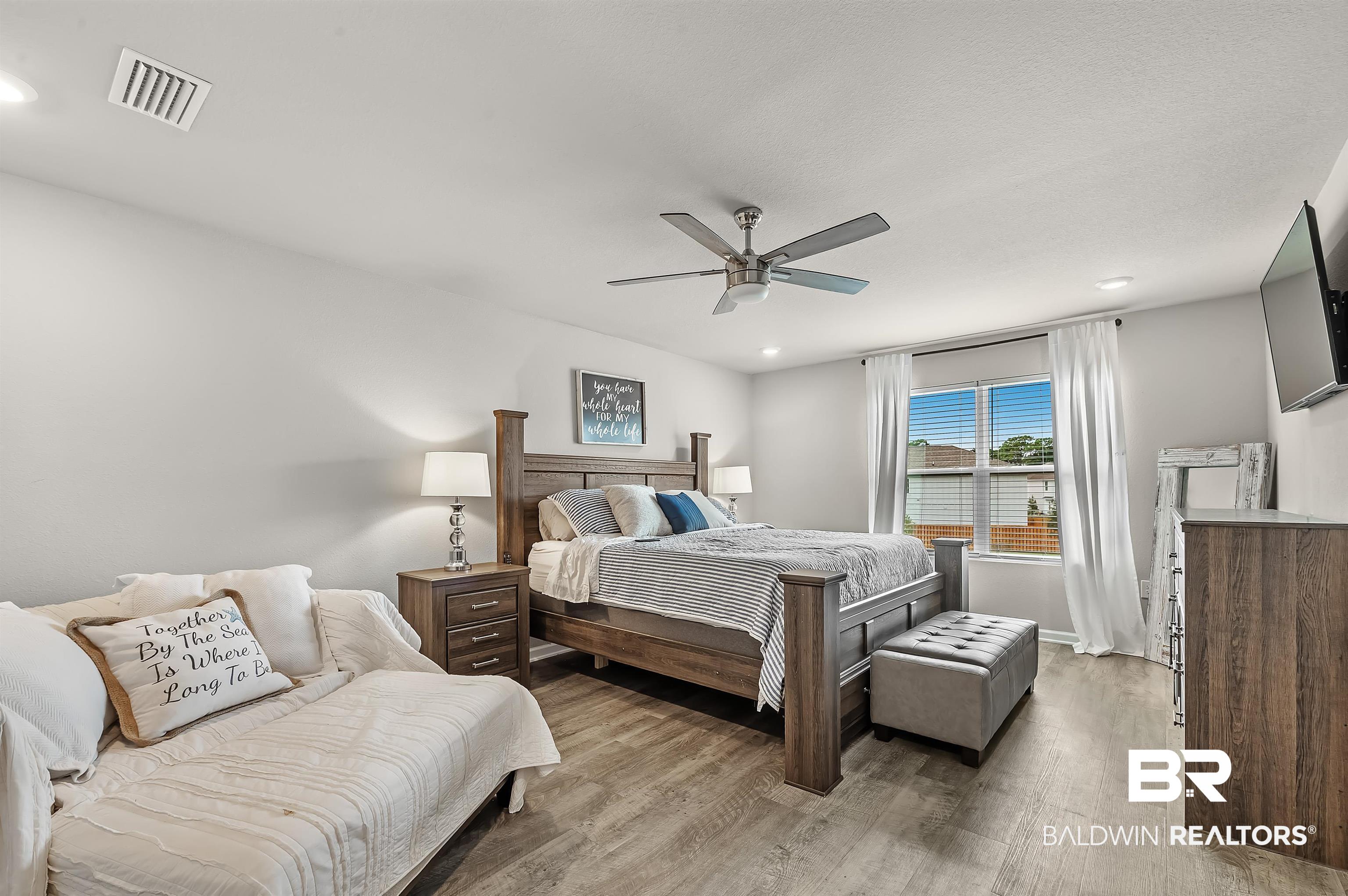 24549 Broken Sound Loop Orange Beach, AL 36561 - Photo 27 of 57 Bedroom with light hardwood / wood-style floors and ceiling fan