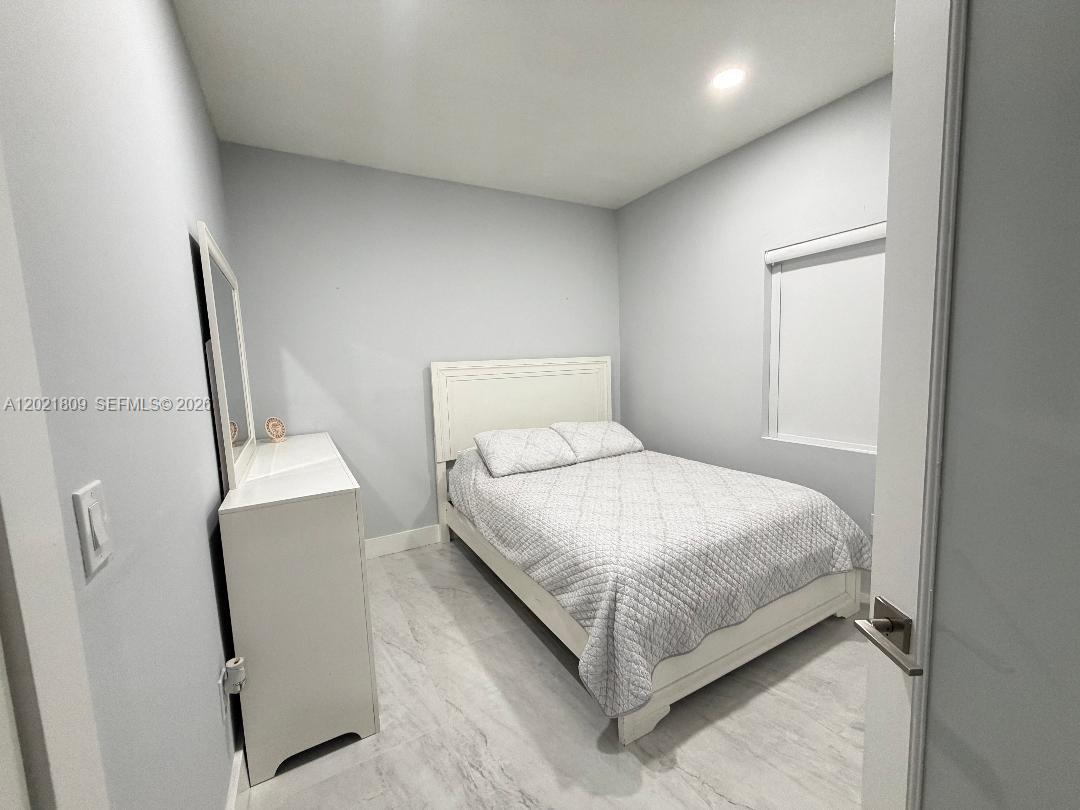6803 Southwest 158th Avenue Miami, FL 33193 - Photo 6 of 6 a bedroom with a bed and a mirror
