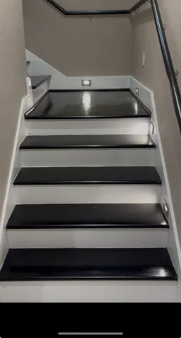a view of a kitchen with a sink and refrigerator