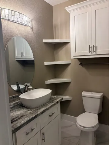 a view of small space with racks on the wall and a window