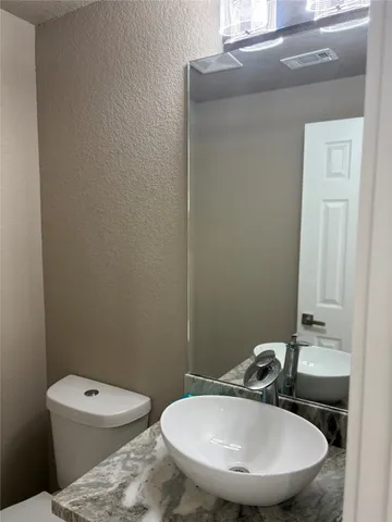 an empty room with furniture and a ceiling fan