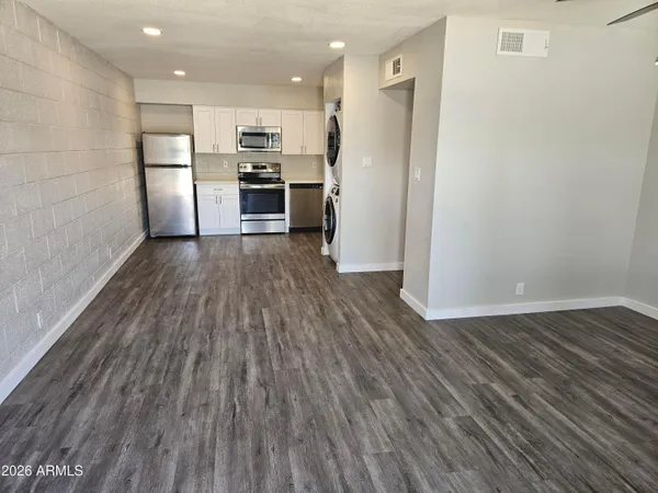 a view of kitchen view wooden floors appliances and cabinets