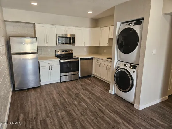 a kitchen with a washer and dryer