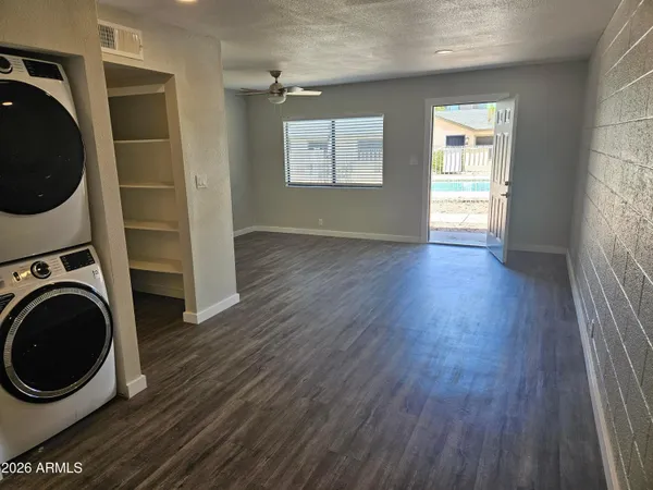 a view of a hallway with wooden floor and a window