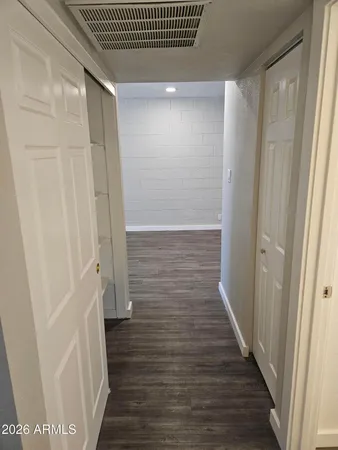 a view of hallway with wooden floor