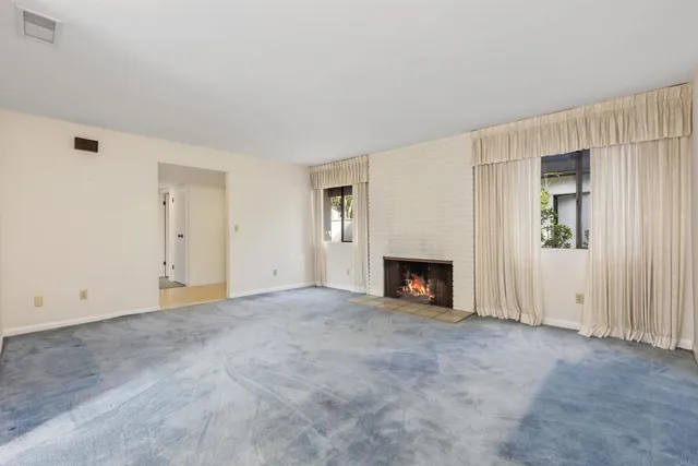 an empty room with fireplace