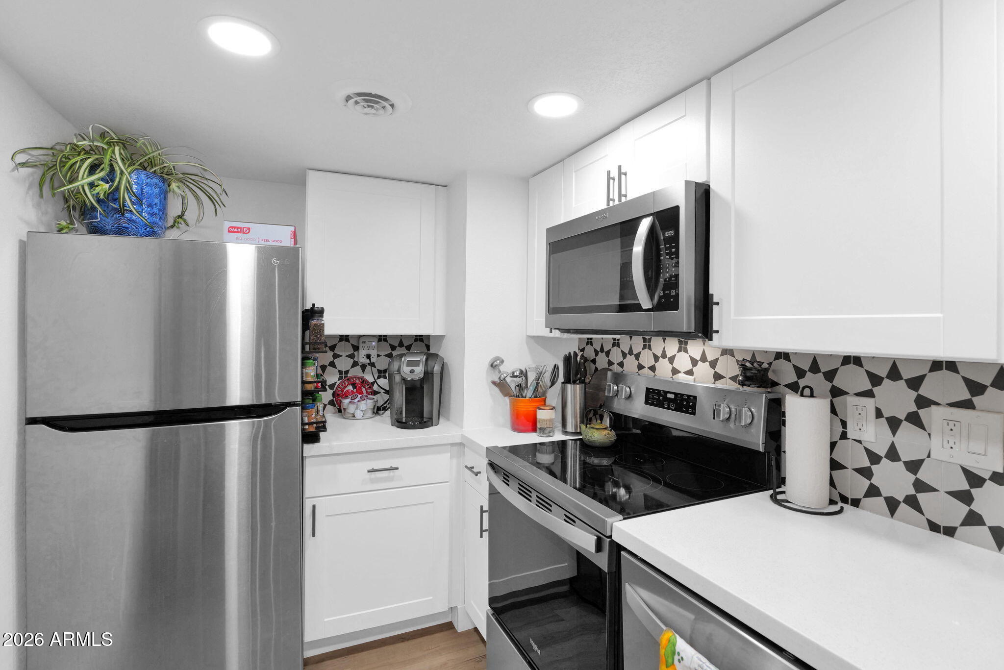 3416 North 44th Street, Unit 69 Phoenix, AZ 85018 - Photo 12 of 19 a kitchen with a refrigerator and a stove top oven