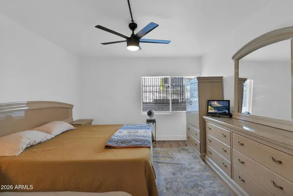 a bedroom with a large bed and a chandelier