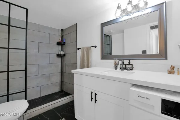 a bathroom with a sink toilet and shower
