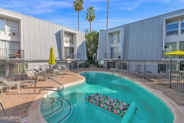 a swimming pool with outdoor seating and yard