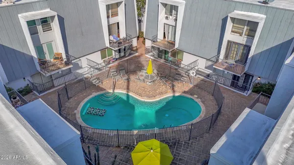 a view of a swimming pool with chairs
