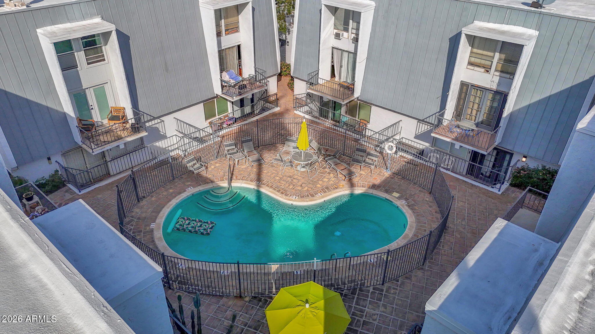 3416 North 44th Street, Unit 69 Phoenix, AZ 85018 - Photo 18 of 19 a view of a swimming pool with chairs