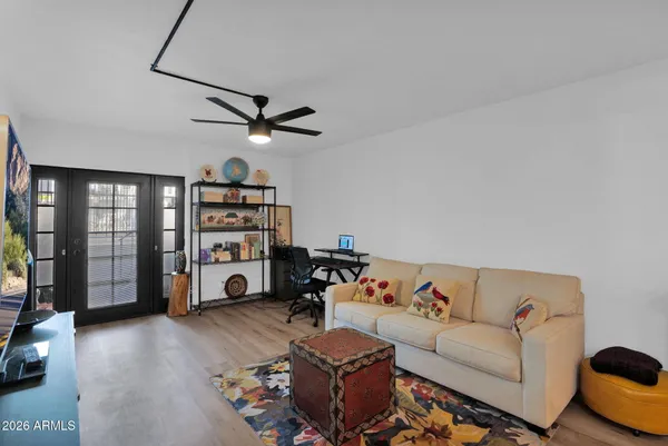 a living room with furniture a ceiling fan and a window